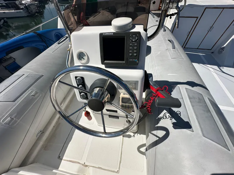 Slide: The Image of 1985 Ocean Alexander Pilothouse helm with steering wheel and navigation equipment. - 28