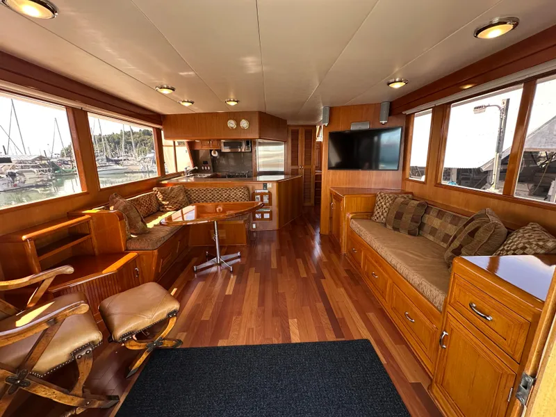 Slide: The Image of Luxurious 1985 Ocean Alexander Pilothouse interior with wood finishes and comfortable seating. - 33