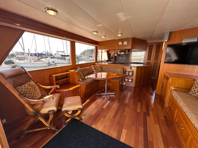 Slide: The Image of Luxurious 1985 Ocean Alexander Pilothouse interior with wood finishes and marina view. - 35