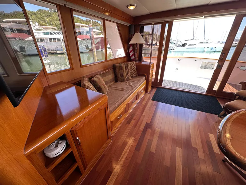 Slide: The Image of Luxurious 1985 Ocean Alexander Pilothouse interior with wooden flooring and marina view. - 40