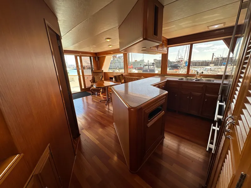 Slide: The Image of Interior of 1985 Ocean Alexander Pilothouse yacht with wooden flooring and spacious kitchen area. - 41