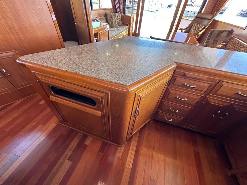 Slide: The Image of 1985 Ocean Alexander Pilothouse interior with wooden cabinetry and granite countertop. - 47