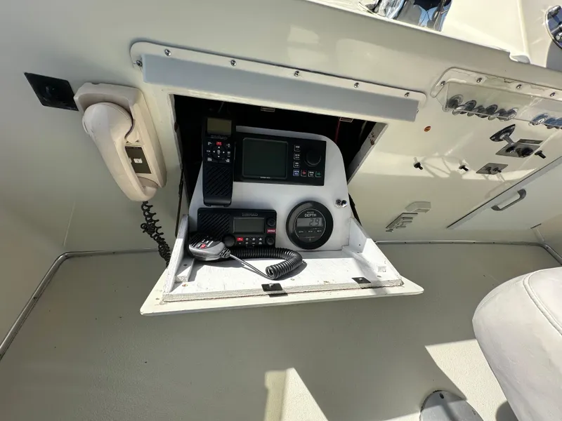 Slide: The Image of 1982 Tollycraft Tri Cabin helm with communication and navigation equipment. - 23
