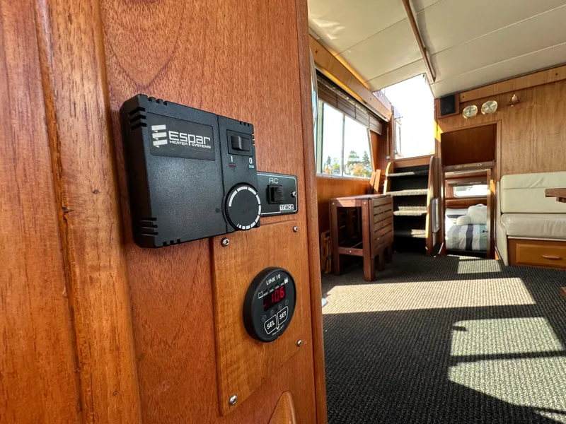 Slide: The Image of 1982 Tollycraft Tri Cabin interior with wooden paneling and modern control panel. - 34