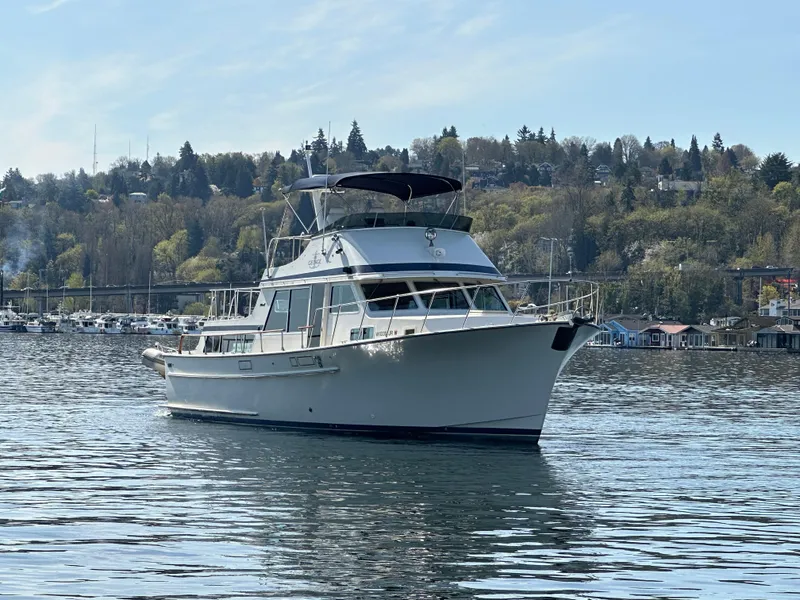 Slide: The Image of 1982 Tollycraft Tri Cabin yacht on calm water with scenic background. - 4