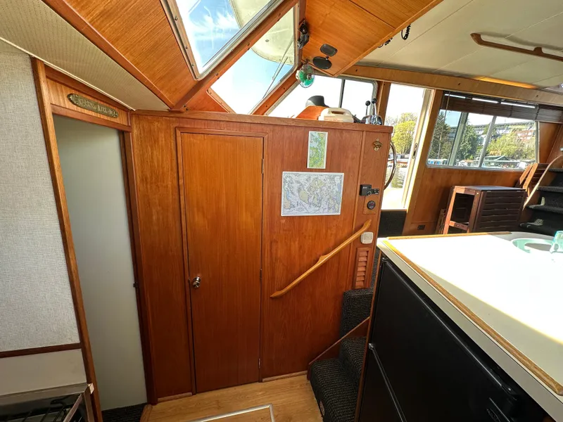 Slide: The Image of 1982 Tollycraft Tri Cabin interior with wood paneling and natural light. - 40