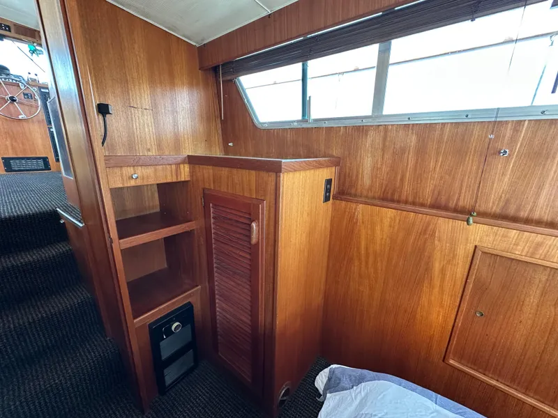 Slide: The Image of 1982 Tollycraft Tri Cabin interior with wooden cabinetry and carpeted flooring. - 48
