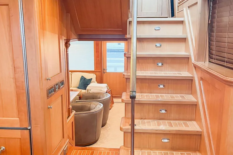 Slide: The Image of Interior of 2001 Nordlund Enclosed Command Bridge with wooden stairs and cozy seating area. - 12