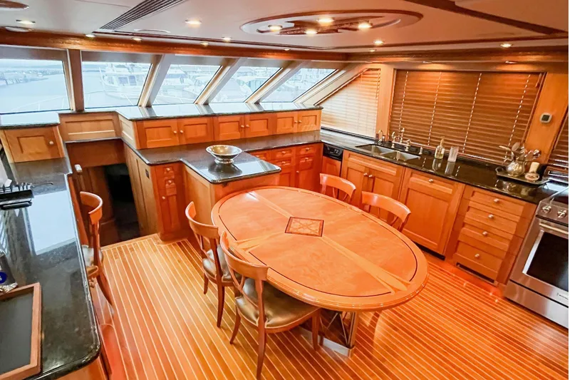 Slide: The Image of Luxurious 2001 Nordlund Enclosed Command Bridge interior with elegant wood finishes and dining area. - 13