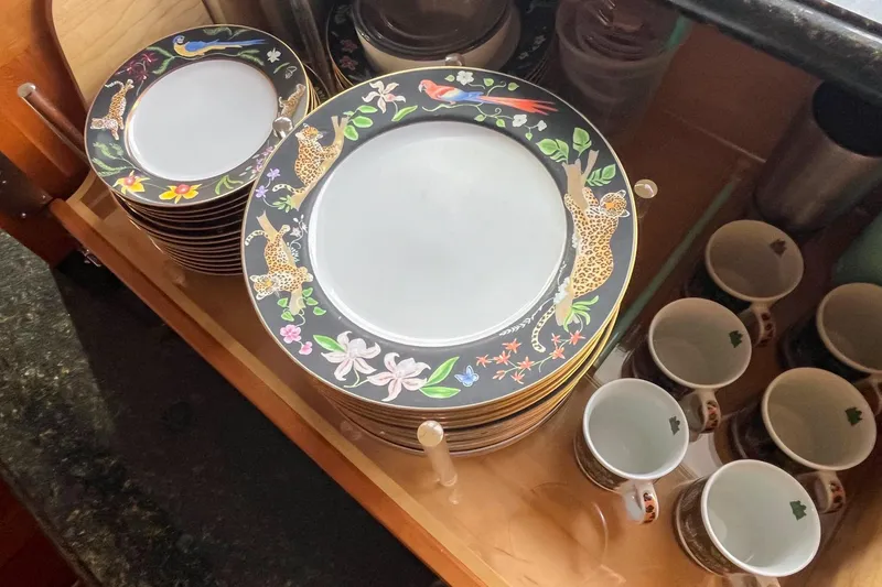 Slide: The Image of Colorful plates with animal designs and cups in a wooden drawer on a Nordlund yacht. - 14