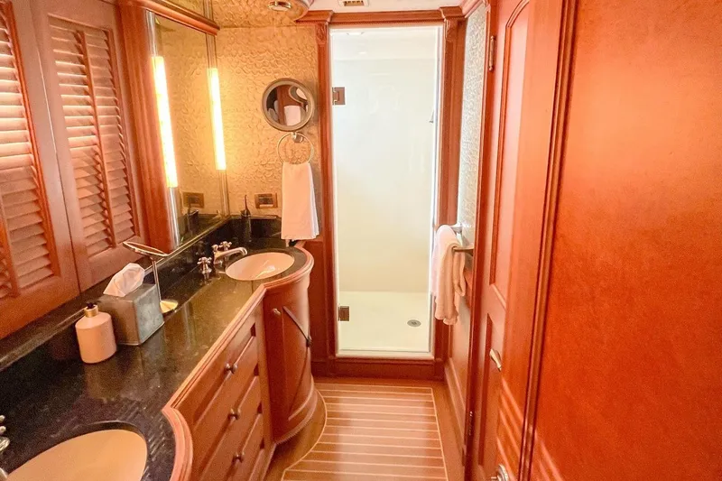 Slide: The Image of Luxurious bathroom in 2001 Nordlund Enclosed Command Bridge yacht with wooden cabinetry and modern fixtures. - 19