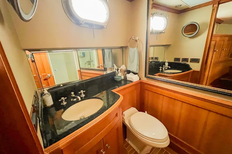 Slide: The Image of Luxurious 2001 Nordlund yacht bathroom with wood paneling and porthole window. - 22