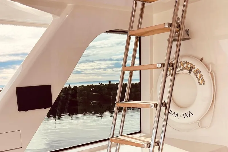 Slide: The Image of Ladder on 2001 Nordlund Enclosed Command Bridge yacht with wooden steps and sleek design. - 25