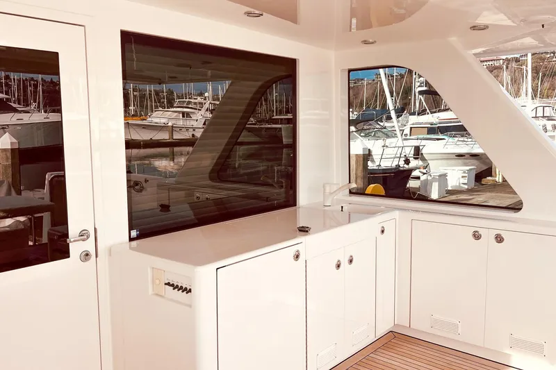 Slide: The Image of 2001 Nordlund Enclosed Command Bridge aft deck and grilling station with excellent wind protection - 26