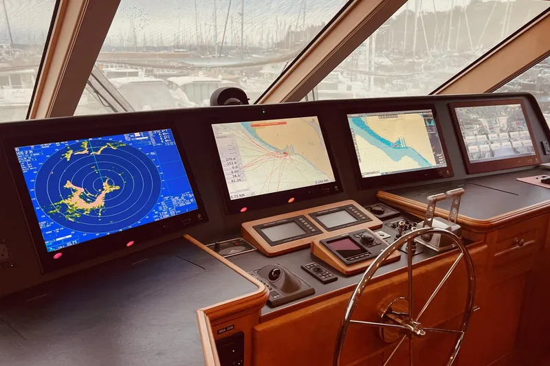 Slide: The Image of Command bridge with navigation screens and steering wheel and state-of-the-art electronics by Yachtsmith Marine. - 3