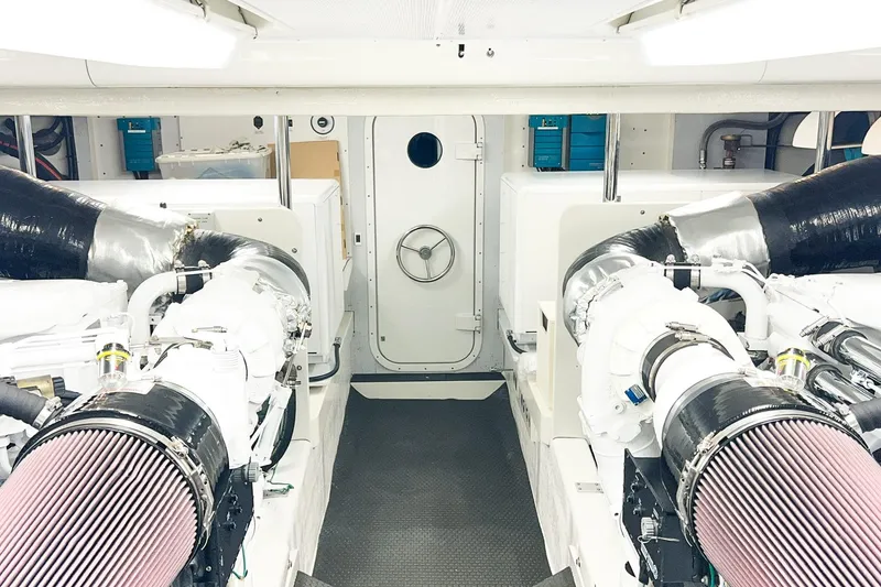 Slide: The Image of Engine room of 2001 Nordlund Enclosed Command Bridge yacht, featuring dual engines and modern equipment. - 33