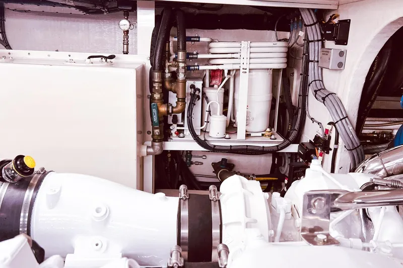 Slide: The Image of Engine room of 2001 Nordlund Enclosed Command Bridge yacht, showcasing mechanical components and piping. - 35
