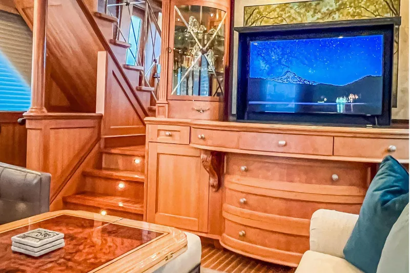 Slide: The Image of A concealed pop-up television (approximately 46”) is seamlessly integrated into finely crafted custom American cherry cabinetry - 7