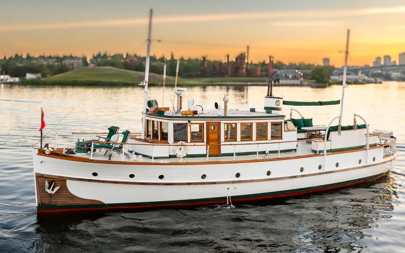 The Image of Vintage 1931 Boeing Custom yacht on serene water at sunset. - 0