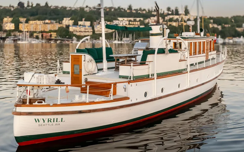 Slide: The Image of Vintage 1931 Boeing custom yacht "Wyrill" on calm water, Seattle backdrop. - 12