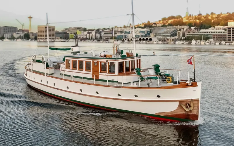 Slide: The Image of Vintage 1931 Boeing Custom yacht cruising on a scenic waterfront. - 18
