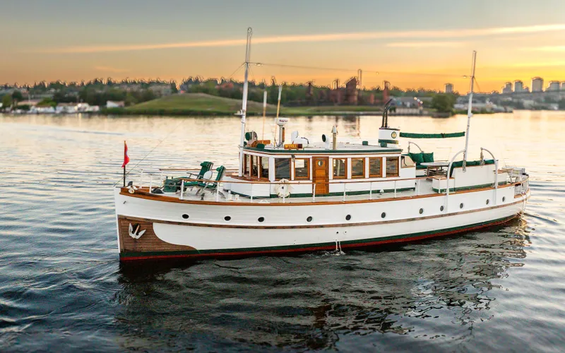 Slide: The Image of Vintage 1931 Boeing Custom yacht on serene water at sunset. - 2
