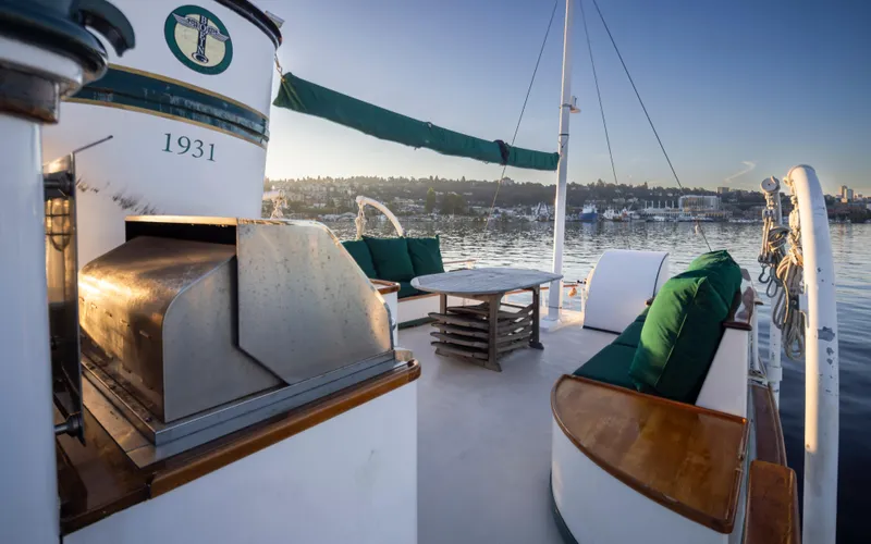 Slide: The Image of Luxurious 1931 Boeing custom yacht deck with seating and scenic waterfront view. - 21