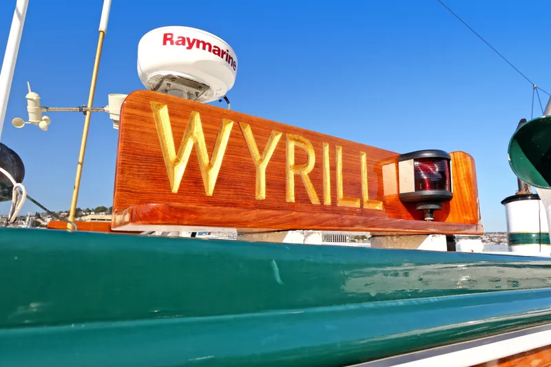 Slide: The Image of Wooden sign "WYRILL" on a boat, blue sky. - 29