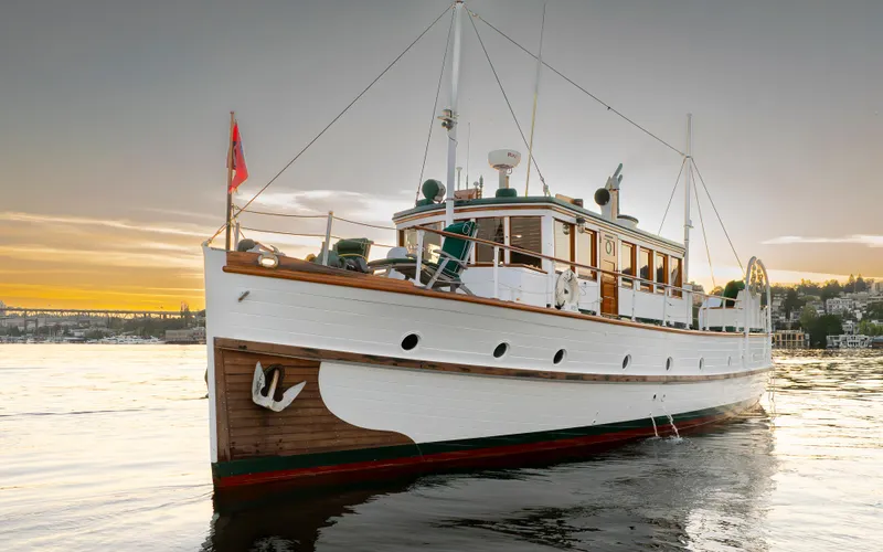 Slide: The Image of Vintage 1931 Boeing Custom yacht on serene water at sunset. - 6