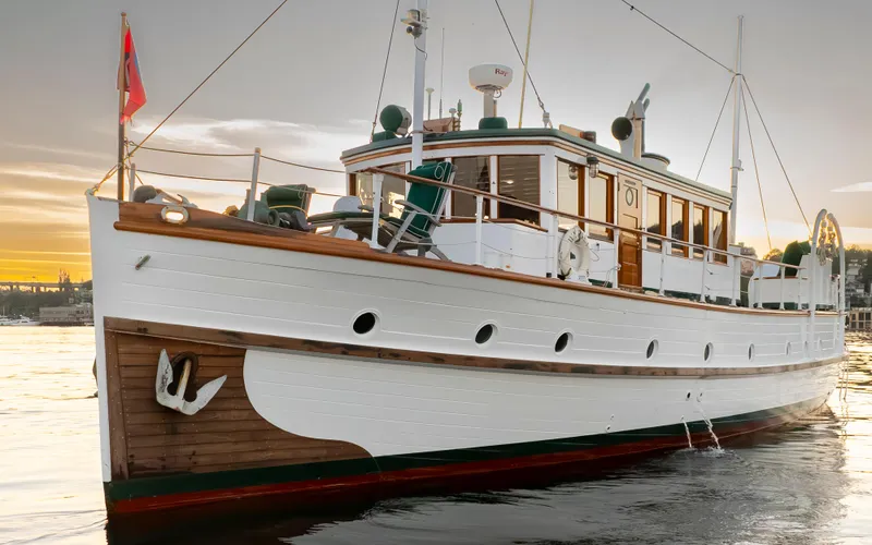 Slide: The Image of Vintage 1931 Boeing Custom yacht on water at sunset, showcasing classic wooden design. - 7