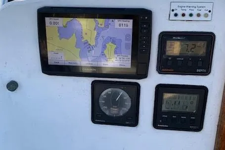 Slide: The Image of Navigation instruments on a 1974 Tartan 30 sailboat dashboard, featuring GPS and depth displays. - 6