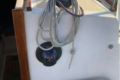 Slide: The Image of 1974 Tartan 30 sailboat cockpit with compass and coiled ropes. - 8