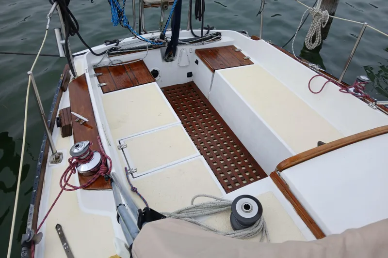 Slide: The Image of 1974 Tartan 30 sailboat cockpit with wooden accents and nautical ropes. - 4