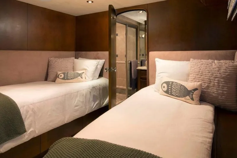 Slide: The Image of Luxurious twin cabin interior on 2006 Broward Raised Pilothouse yacht, featuring cozy bedding and decor. - 11