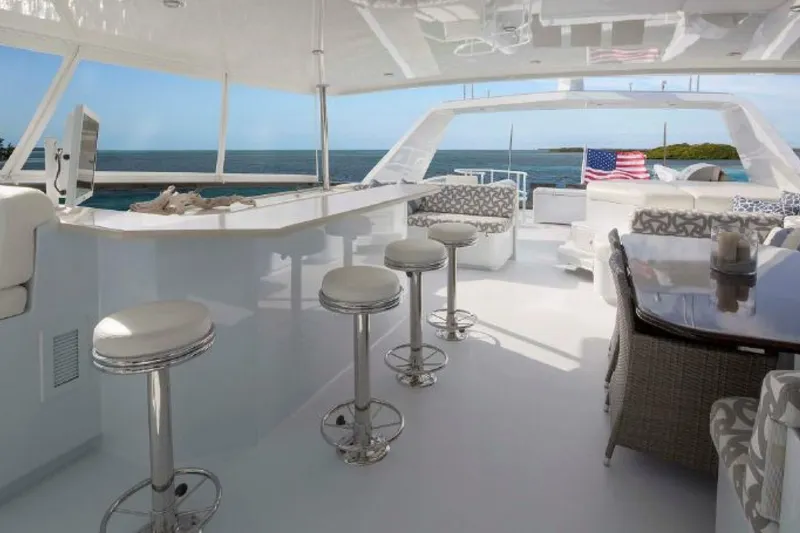 Slide: The Image of Luxurious 2006 Broward Raised Pilothouse yacht interior with bar stools and ocean view. - 12
