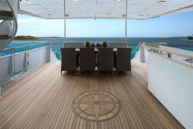 Slide: The Image of Luxurious 2006 Broward Raised Pilothouse yacht deck with ocean view and elegant dining area. - 13