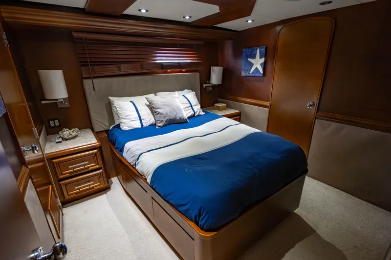 Slide: The Image of Luxurious bedroom in 2006 Broward Raised Pilothouse yacht with elegant wood finishes. - 22