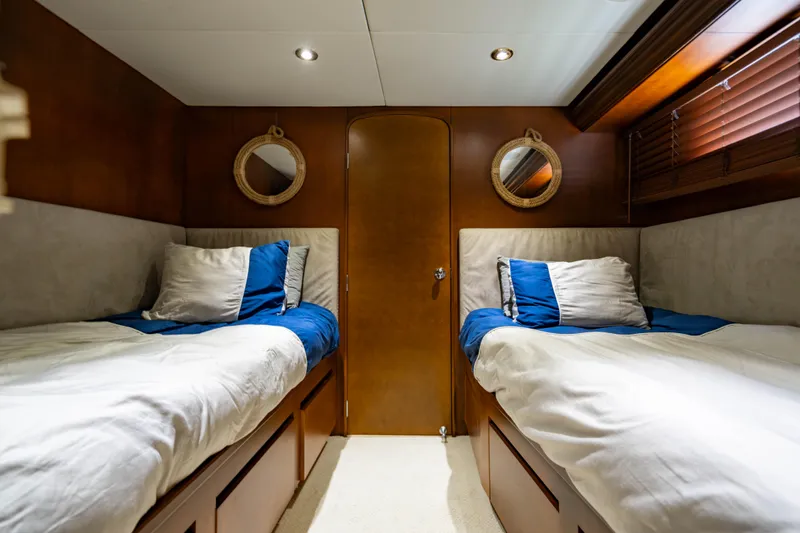 Slide: The Image of Luxurious twin cabin in 2006 Broward Raised Pilothouse yacht with elegant wood finishes. - 25