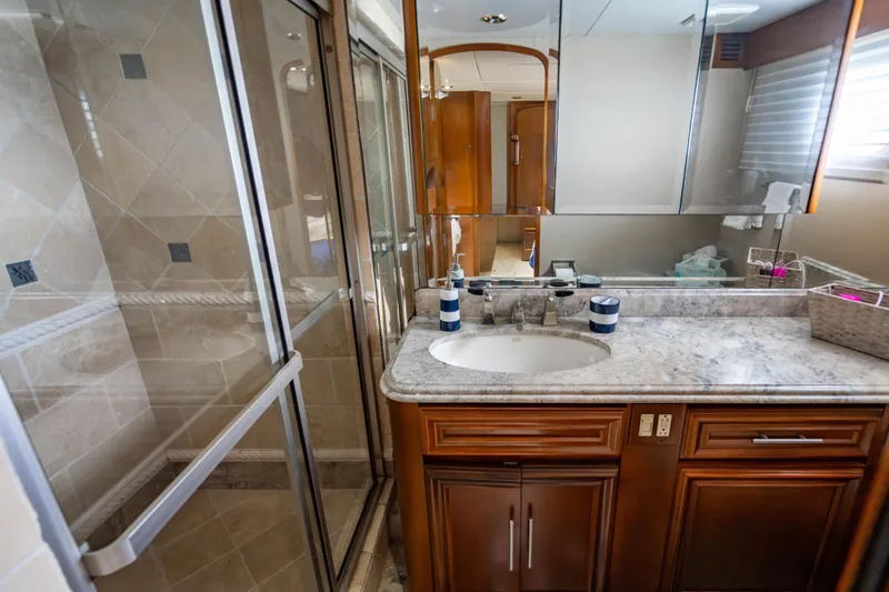 Slide: The Image of Luxurious bathroom in 2006 Broward Raised Pilothouse yacht with marble countertop and glass shower. - 26
