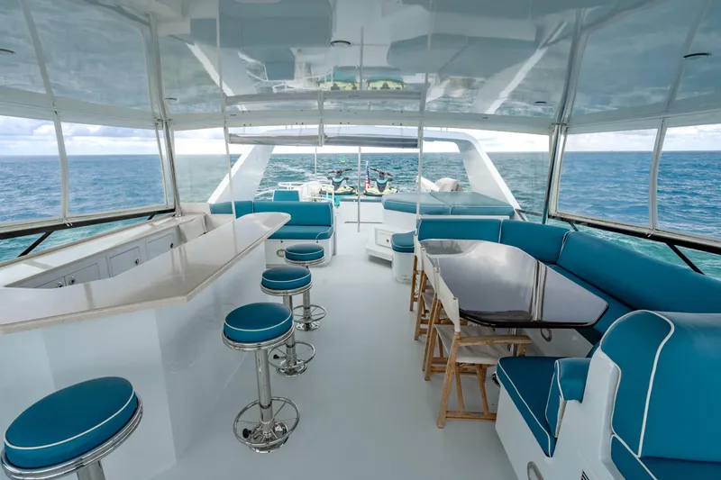 Slide: The Image of Luxurious 2006 Broward Raised Pilothouse yacht interior with ocean view, featuring bar and seating area. - 27