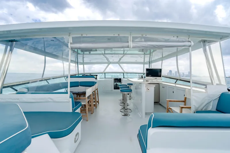 Slide: The Image of Luxurious 2006 Broward Raised Pilothouse yacht interior with blue seating and ocean view. - 28