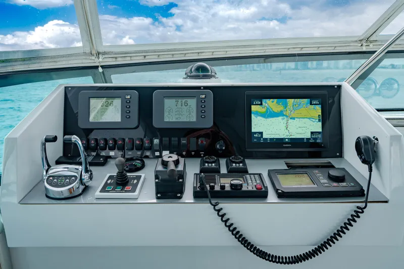 Slide: The Image of Control panel of a 2006 Broward Raised Pilothouse yacht with navigation screens and controls. - 29