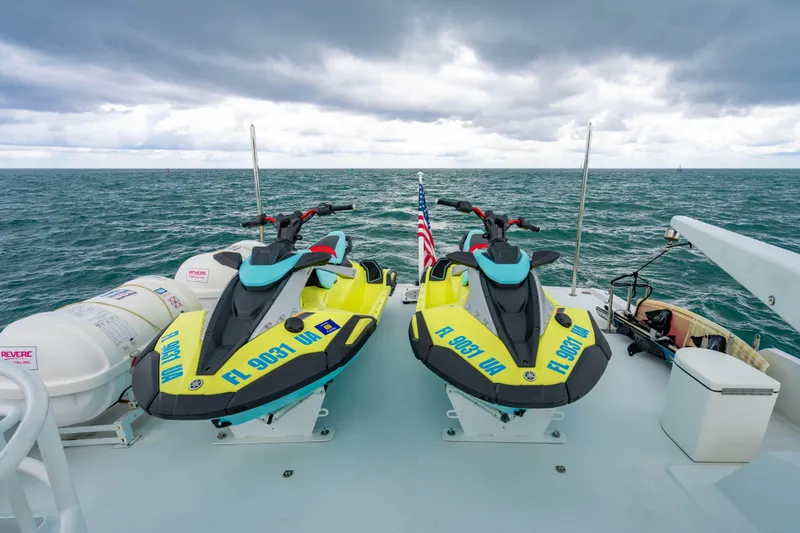 Slide: The Image of Two jet skis on a 2006 Broward Raised Pilothouse yacht deck, ocean backdrop. - 34