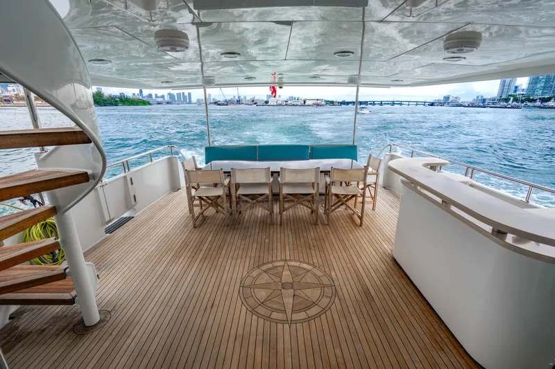Slide: The Image of Luxurious 2006 Broward Raised Pilothouse yacht deck with seating, ocean view, and spiral staircase. - 35