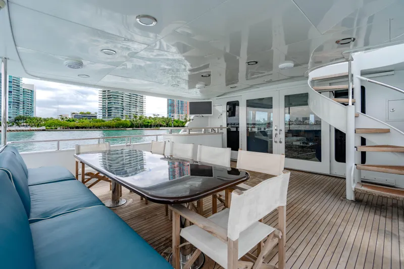Slide: The Image of Luxurious 2006 Broward Raised Pilothouse yacht deck with seating and scenic waterfront view. - 37