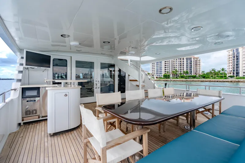 Slide: The Image of Luxurious 2006 Broward Raised Pilothouse yacht deck with dining area and waterfront view. - 38