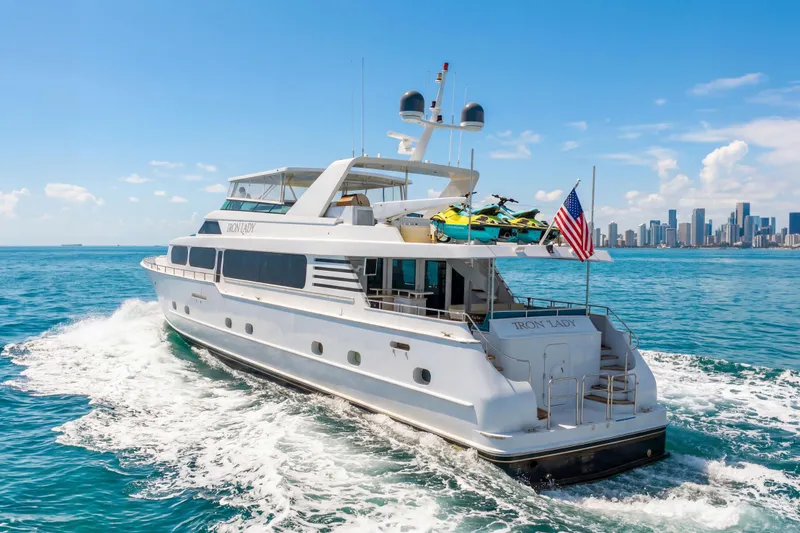 Slide: The Image of Luxury 2006 Broward Raised Pilothouse yacht cruising near city skyline on a sunny day. - 40