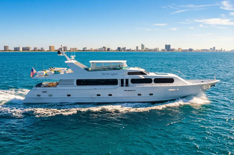 Slide: The Image of Luxury 2006 Broward Raised Pilothouse yacht cruising on blue ocean near city skyline. - 41