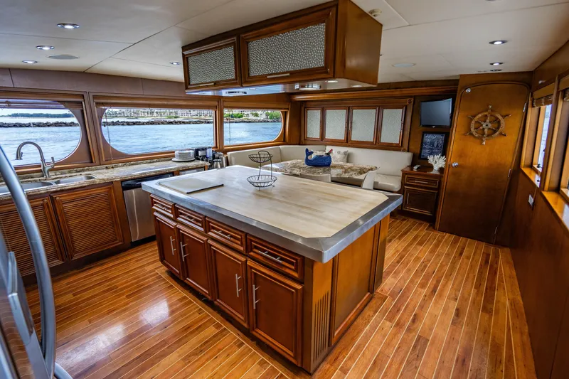 Slide: The Image of Luxurious 2006 Broward Raised Pilothouse yacht interior with elegant wood finishes and spacious kitchen. - 5