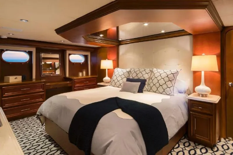Slide: The Image of Luxurious bedroom in 2006 Broward Raised Pilothouse yacht with elegant decor and ambient lighting. - 8